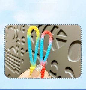 Detail of colorful gradient PVC woven keychain straps in blue yellow and red blue