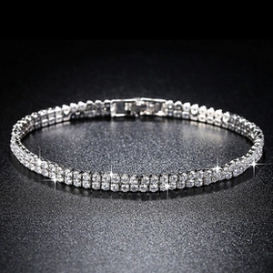 Close-up of sparkling double-row zircon tennis bracelet with silver finish and star flare