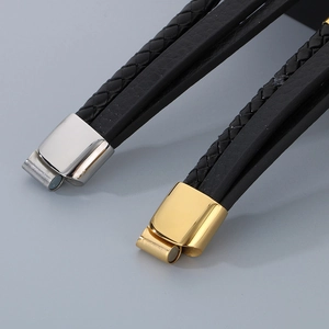 Detail of multi-layer leather bracelet with polished silver and gold magnetic clasp