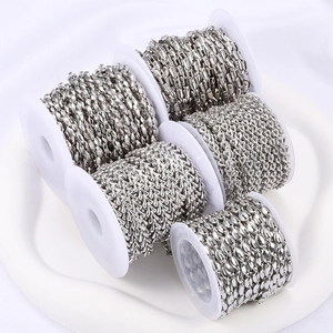 Polished silver stainless steel DIY chains in various link styles on white ceramic