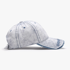 Distressed light blue denim baseball cap with letter embroidery and frayed brim details
