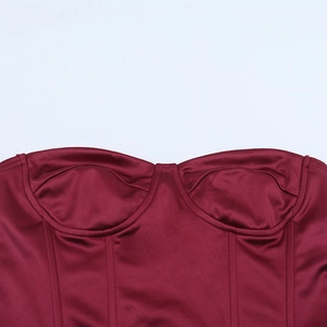 Detail of burgundy satin corset top with boning and deep V-neckline evening dress texture