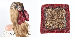 Detail of red and brown leopard print square head scarf with golden chain patterns