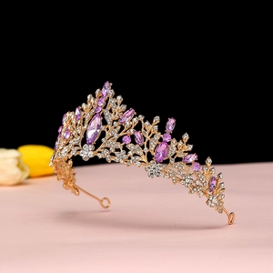 Detailed macro view of baroque gold crown with purple crystals and white rhinestones