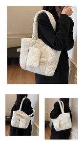 Detail of cream quilted tote bag with embroidered flower accents and small matching pouch