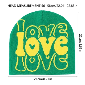 Detail of green knitted beanie with yellow LOVE graffiti print showing knit texture