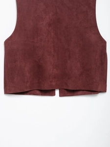 Detailed macro view of burgundy suede vest hem with high quality stitching and texture