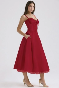 Detail of red floral midi dress showing ruched chest tie and hidden side pockets