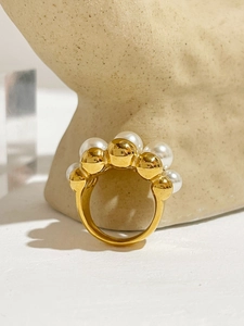Detailed view of gold multi-layer beaded ring featuring five graduated inlaid pearls