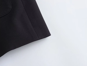 Close-up of black casual jacket fabric showing premium weave texture and seam stitching