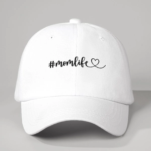 White cotton baseball cap with black #momlife embroidery and adjustable strap back