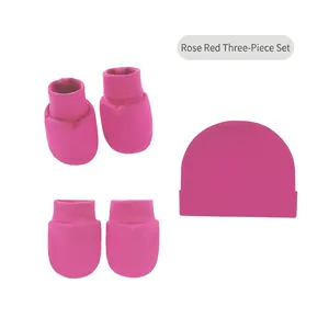 Rose red cotton infant set with baby hat, matching mittens, and booties on white background