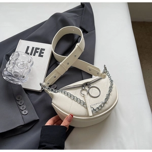 Detail of white dumpling bag showing litchi leather texture and silver metal chain strap