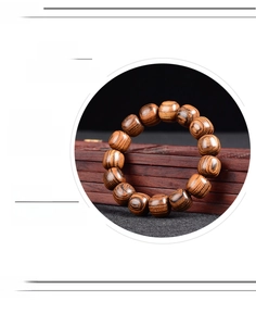Macro detail of sandalwood Buddhist prayer beads showing dense natural wood grain and oily texture