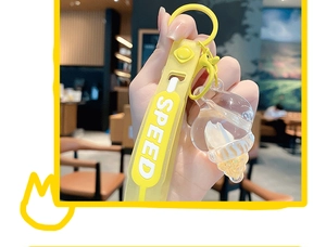 Detailed macro view of yellow seashell keychain with glitter and SPEED silicone strap