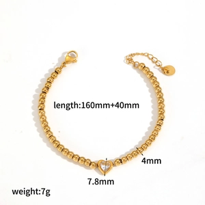 Detailed view of gold beaded tennis bracelet featuring a sparkling zircon heart pendant