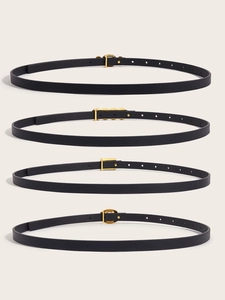 Close-up of four black leather slim belts with different gold metal buckles for women