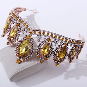 Detailed macro view of rose gold bridal crown with yellow oval gems and clear rhinestones