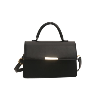 Minimalist black faux leather handbag with gold metal clasp and adjustable shoulder strap