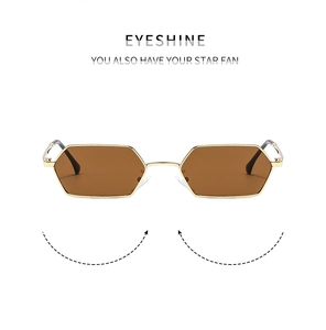 Close-up of retro hexagonal gold metal frame sunglasses with brown lenses and sleek temples