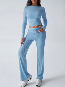 Close-up of light blue two-piece Y2K tracksuit featuring drawstring wide-leg pants