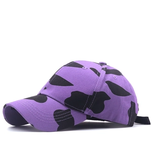 Purple cow print baseball cap with black spots and curved brim for men and women