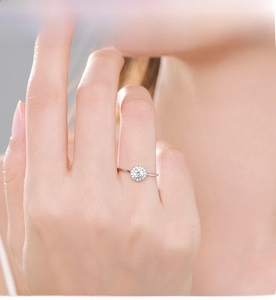 Close-up of S925 sterling silver ring with sparkling round halo zircon on model's finger