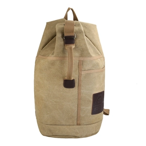 Retro khaki canvas travel backpack with brown leather trim in a 45-degree side view