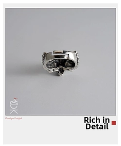 Detailed relief carving of a vintage punk skull wing open ring in distressed silver finish