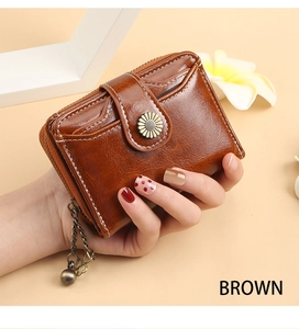 Brown leather short wallet for women featuring flower buckle and multi-card slots