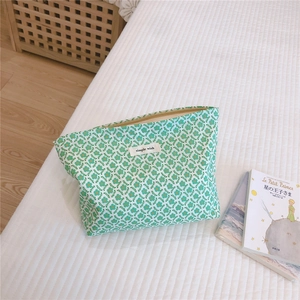 Floral cotton makeup bag with green patterns and simple wish label on white fabric