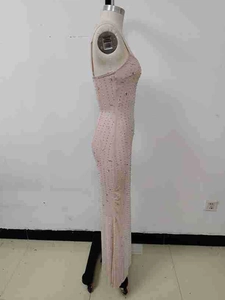 Detailed view of shimmering sequins and rhinestones on the mesh fabric of a nude evening gown