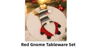 Detail of red gnome cutlery holder with golden silverware on a white plate