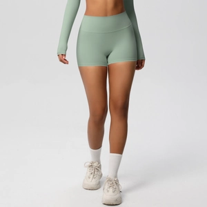 Detail of high-waist peach lift yoga shorts in light green featuring double-sided brushed fabric