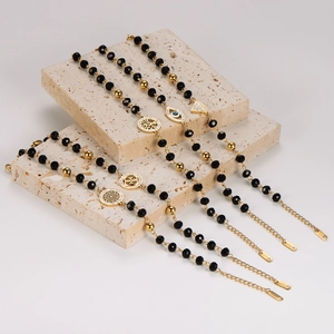 Five gold stainless steel beaded bracelets with tree of life and evil eye charms on stones