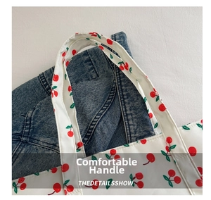 Close-up of the cherry print tote bag handle featuring high-quality canvas fabric texture