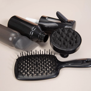 Black hair care set with spray bottle, scalp massage brush and cushion comb