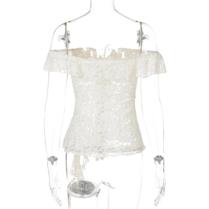 Detail view of the lace back and trailing ribbons on a white off-shoulder top