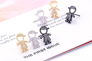 Macro shot of cubic zirconia boy ear studs in gold, silver, and black metal finishes