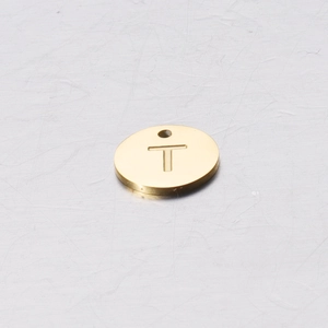 Close-up of 12mm mirror polished golden stainless steel round charm with letter T