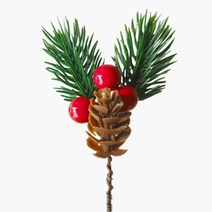 Artificial Christmas pine branch with green needles, red berries and a brown pine cone