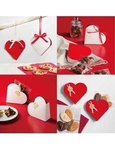 Detailed view of heart-shaped gift boxes with satin ribbons and decorative seals