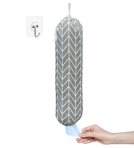 Detail of wall-mounted grocery bag holder showing grey chevron pattern and bottom dispenser