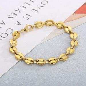 Detailed macro view of gold-plated coffee bean link bracelet with lobster clasp