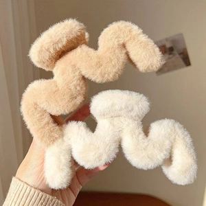 Detailed close-up of camel and cream plush wavy hair claw clips with soft fur texture