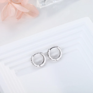 Close-up of S925 sterling silver hoop earrings with Medusa Greek fret pattern engraving
