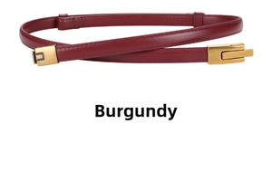 Detail of wine red slim leather belt with textured gold buckle and fine stitching