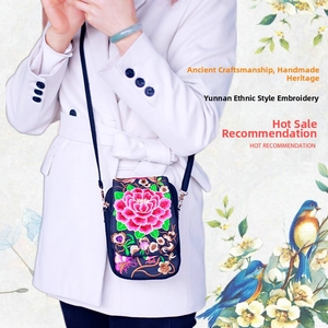 Detailed embroidery of pink peony on ethnic style crossbody bag with black shoulder strap