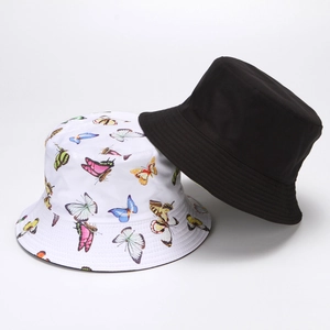 Detail of black and white cotton bucket hats featuring cute butterfly embroidery