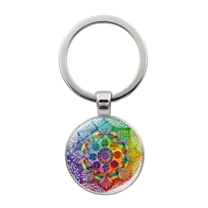 Detail of round silver keychain featuring a colorful mandala art glass dome pendant